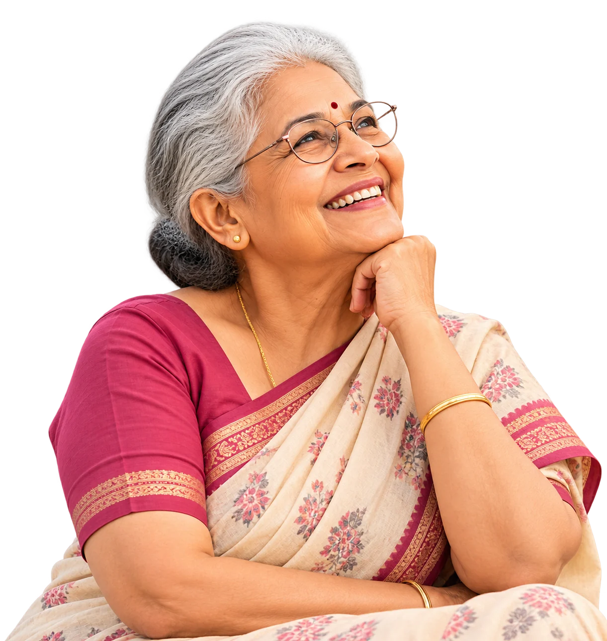 Lakshmi, 68, smiling in her reading glasses